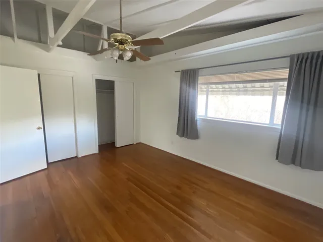 a view of a livingroom with a ceiling fan and window