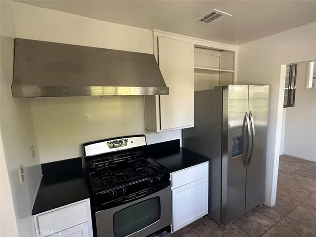 a kitchen with stainless steel appliances a stove and a refrigerator
