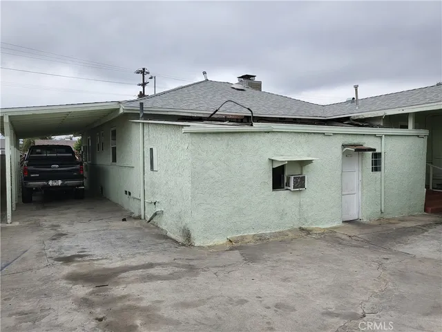 a view of garage and car parked