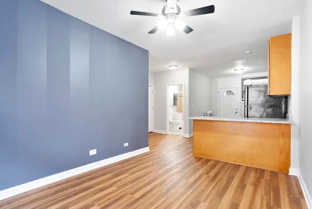 a view of kitchen with sink and wooden floor