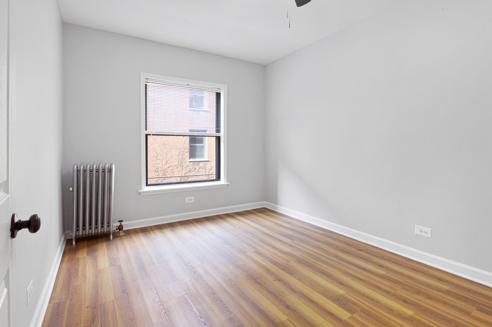 1702 West Juneway Terrace, Unit 3C Chicago, IL 60626 - Photo 8 of 15 an empty room with wooden floor and windows
