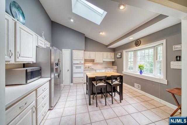 225 Doxey Drive Park Ridge, NJ 07656 - Photo 2 of 30 a kitchen with granite countertop a table chairs microwave and refrigerator