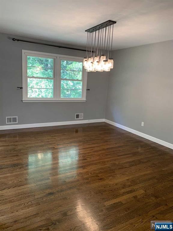 225 Doxey Drive Park Ridge, NJ 07656 - Photo 25 of 30 an empty room with wooden floor and windows