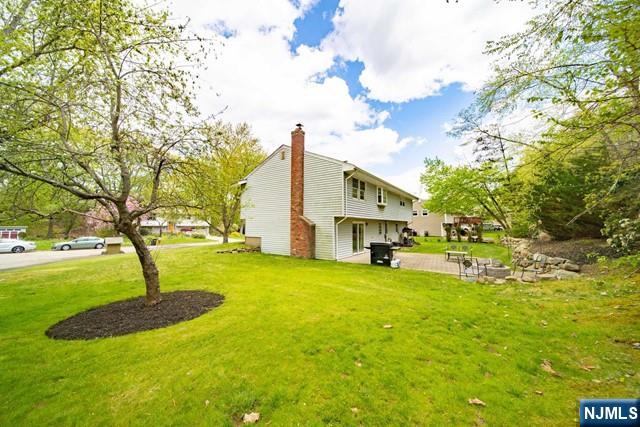 225 Doxey Drive Park Ridge, NJ 07656 - Photo 29 of 30 a view of a house with a yard and sitting area