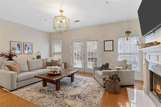 a living room with furniture a fireplace and a flat screen tv