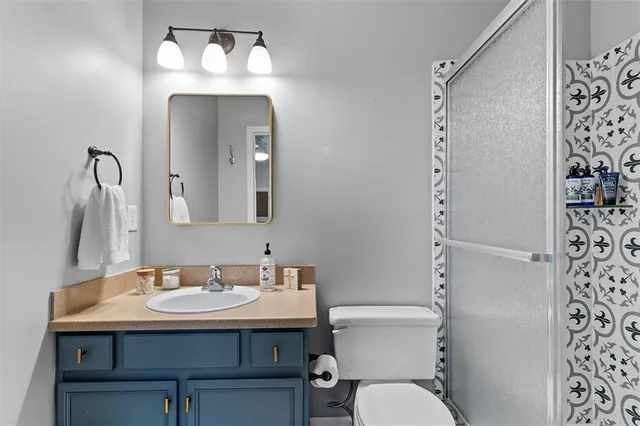 a bathroom with a toilet a sink and a mirror