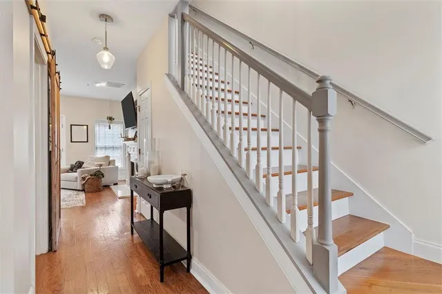 a view of entryway and hall with wooden floor