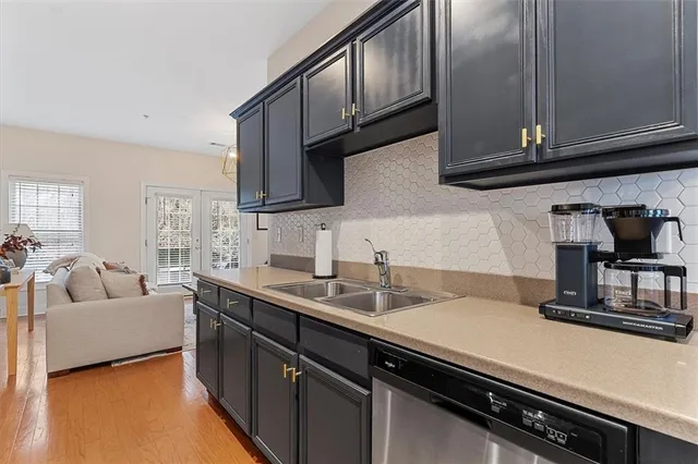 a kitchen with a sink dishwasher a stove and a microwave oven