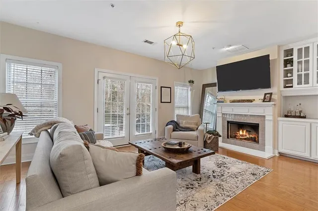 a living room with furniture a flat screen tv and a fireplace