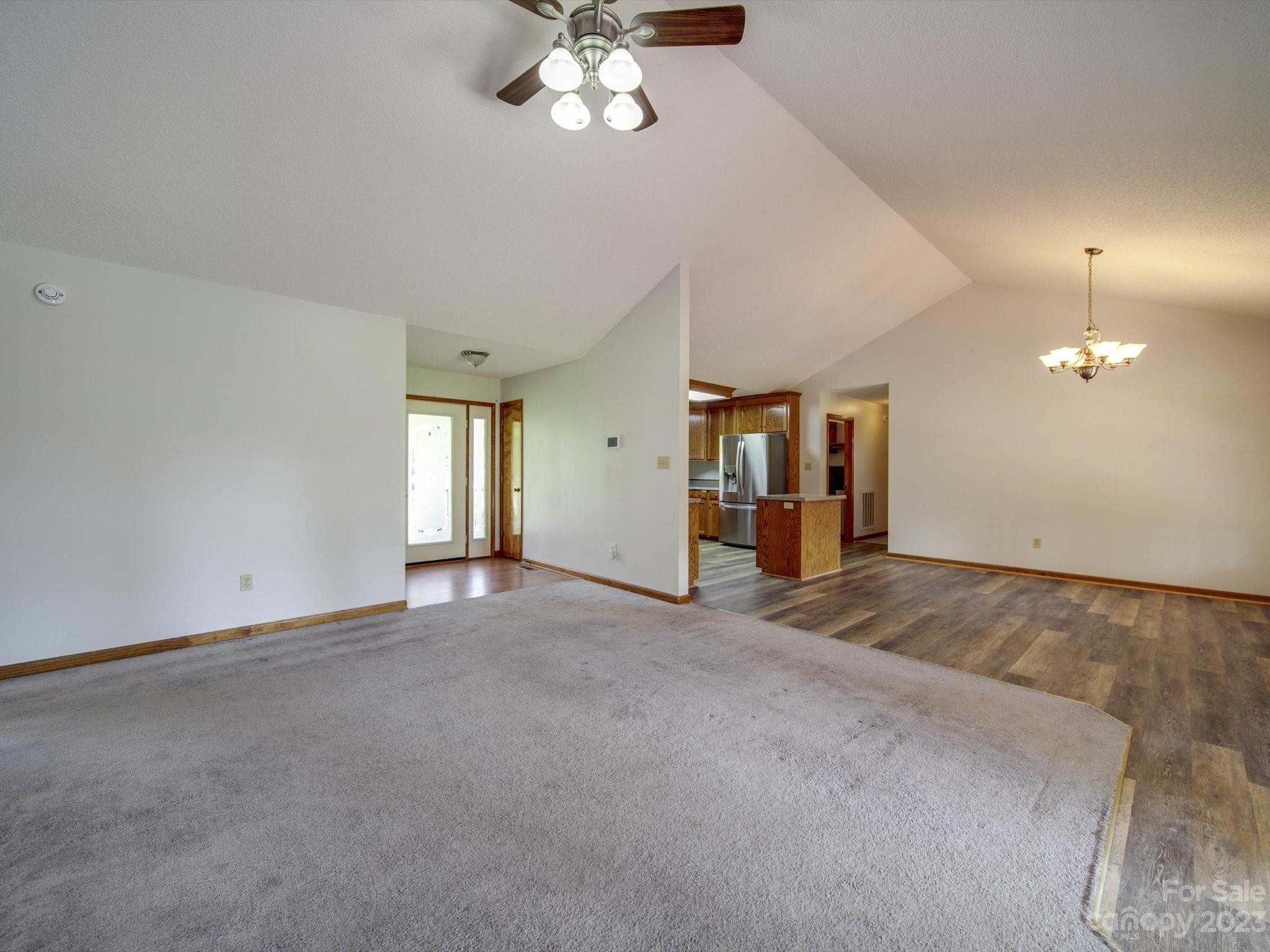5351 Faith Road Salisbury, NC 28146 - Photo 11 of 32 an empty room with chandelier fan and windows