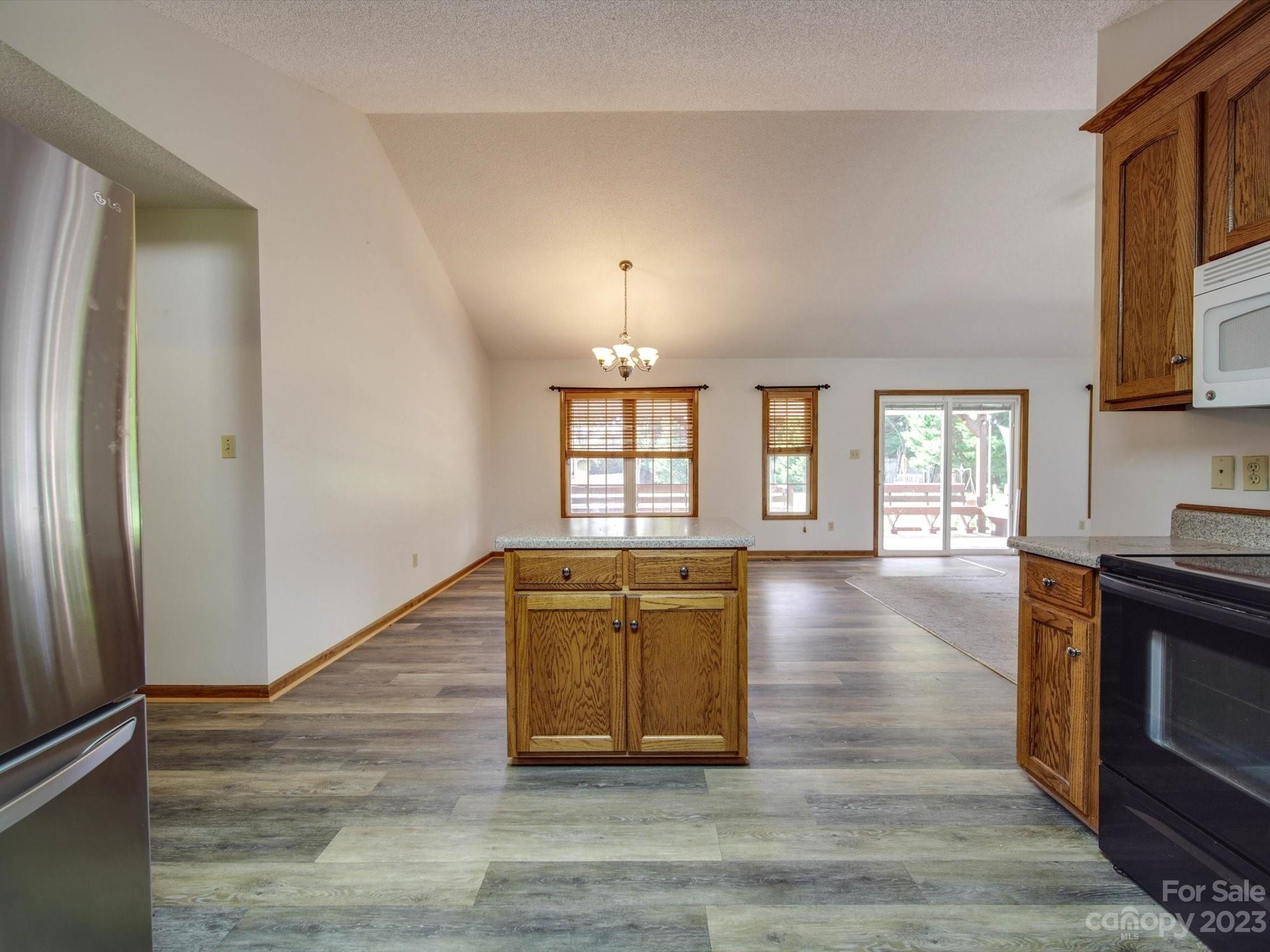 5351 Faith Road Salisbury, NC 28146 - Photo 6 of 32 a view of empty room with wooden floor and fireplace