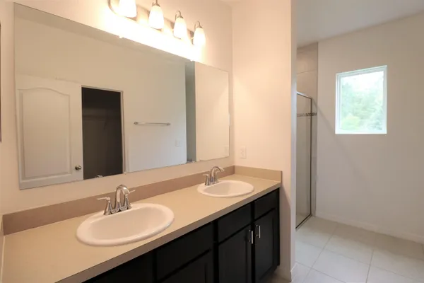 a bathroom with a granite countertop shower and a sink