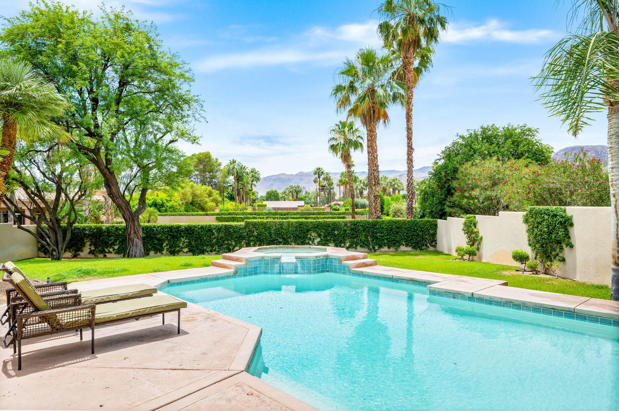 70615 Sunny Lane Rancho Mirage, CA 92270 - Photo 2 of 41 a view of a swimming pool with a garden and plants