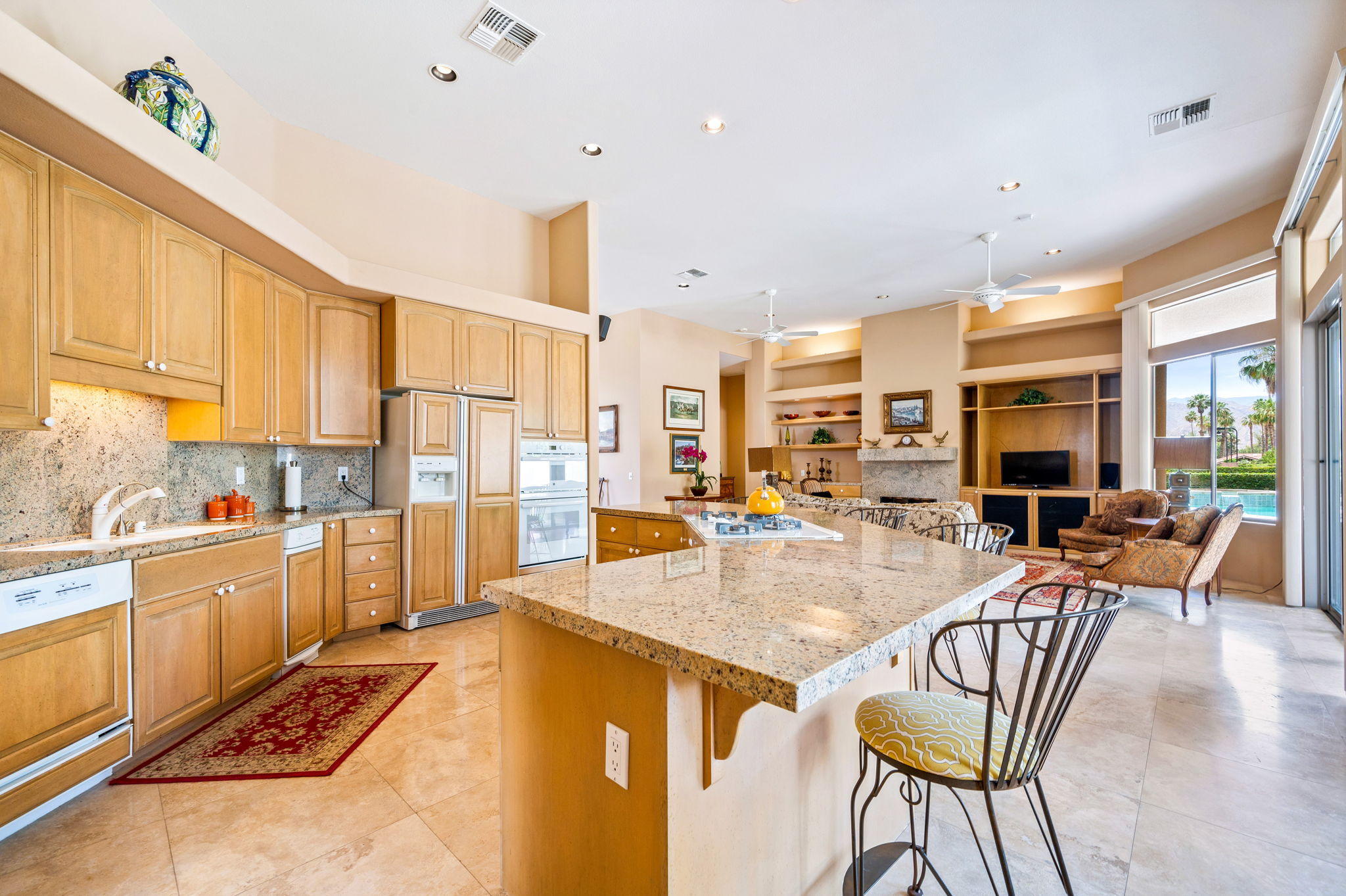 70615 Sunny Lane Rancho Mirage, CA 92270 - Photo 12 of 41 a view of a kitchen with kitchen island dining table and stainless steel appliances