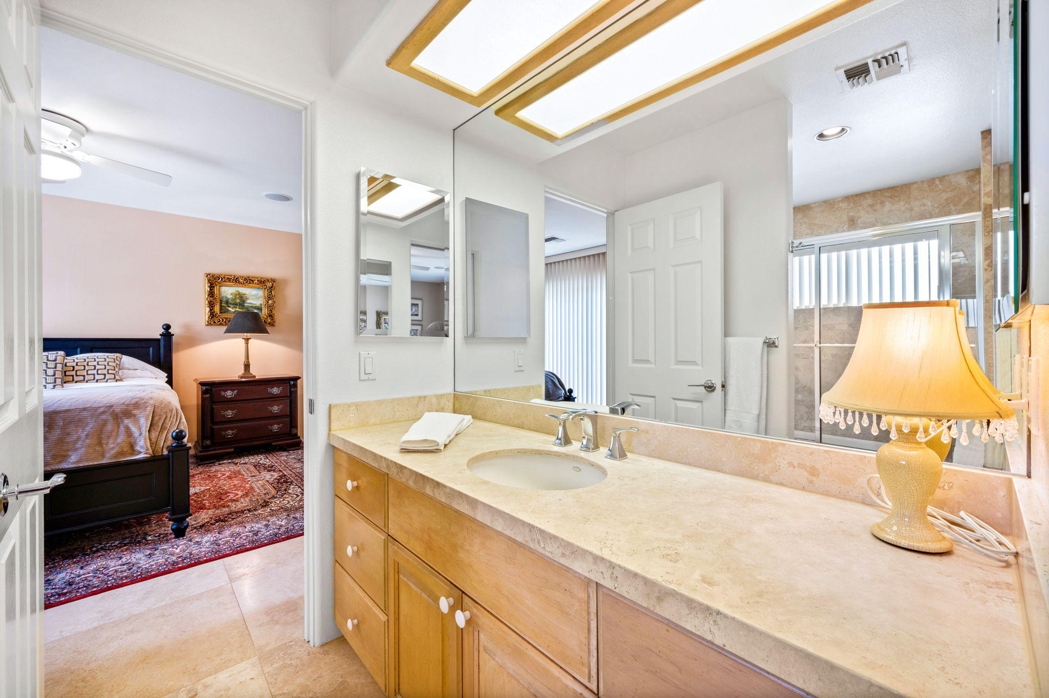 70615 Sunny Lane Rancho Mirage, CA 92270 - Photo 34 of 41 a spacious bathroom with a granite countertop sink and a mirror