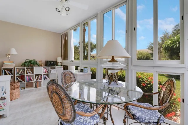 a dining room with furniture a rug and a large window
