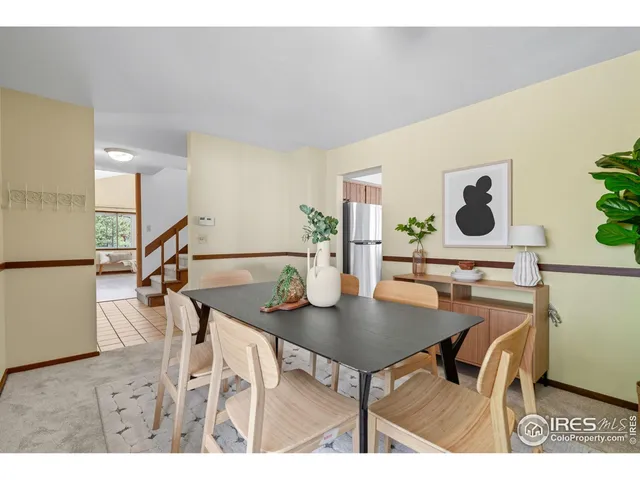 a view of a dining room with furniture and a potted plant
