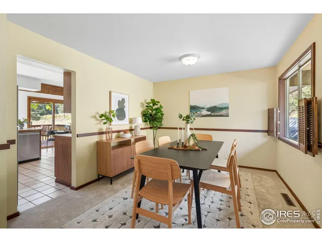 a view of a dining room with furniture and a kitchen