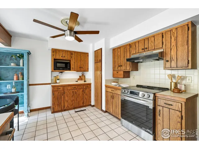 a kitchen with a stove a sink and a refrigerator