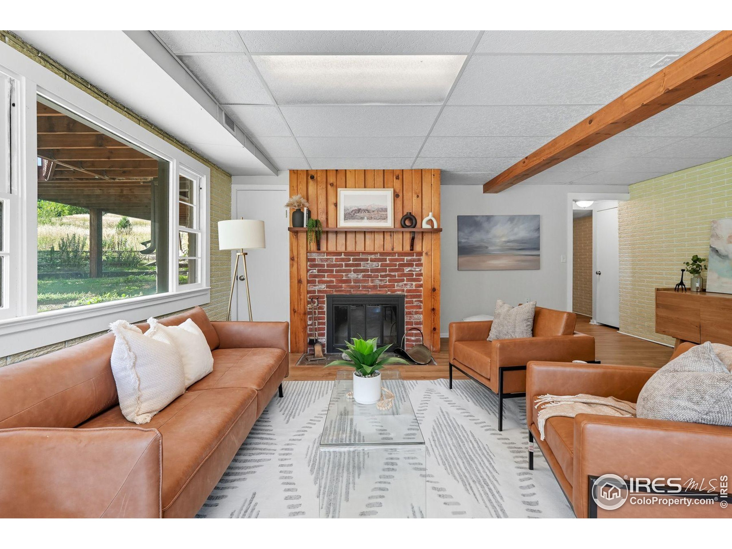 1037 Wagonwheel Gap Road Boulder, CO 80304 - Photo 26 of 43 a living room with furniture large window and a fireplace