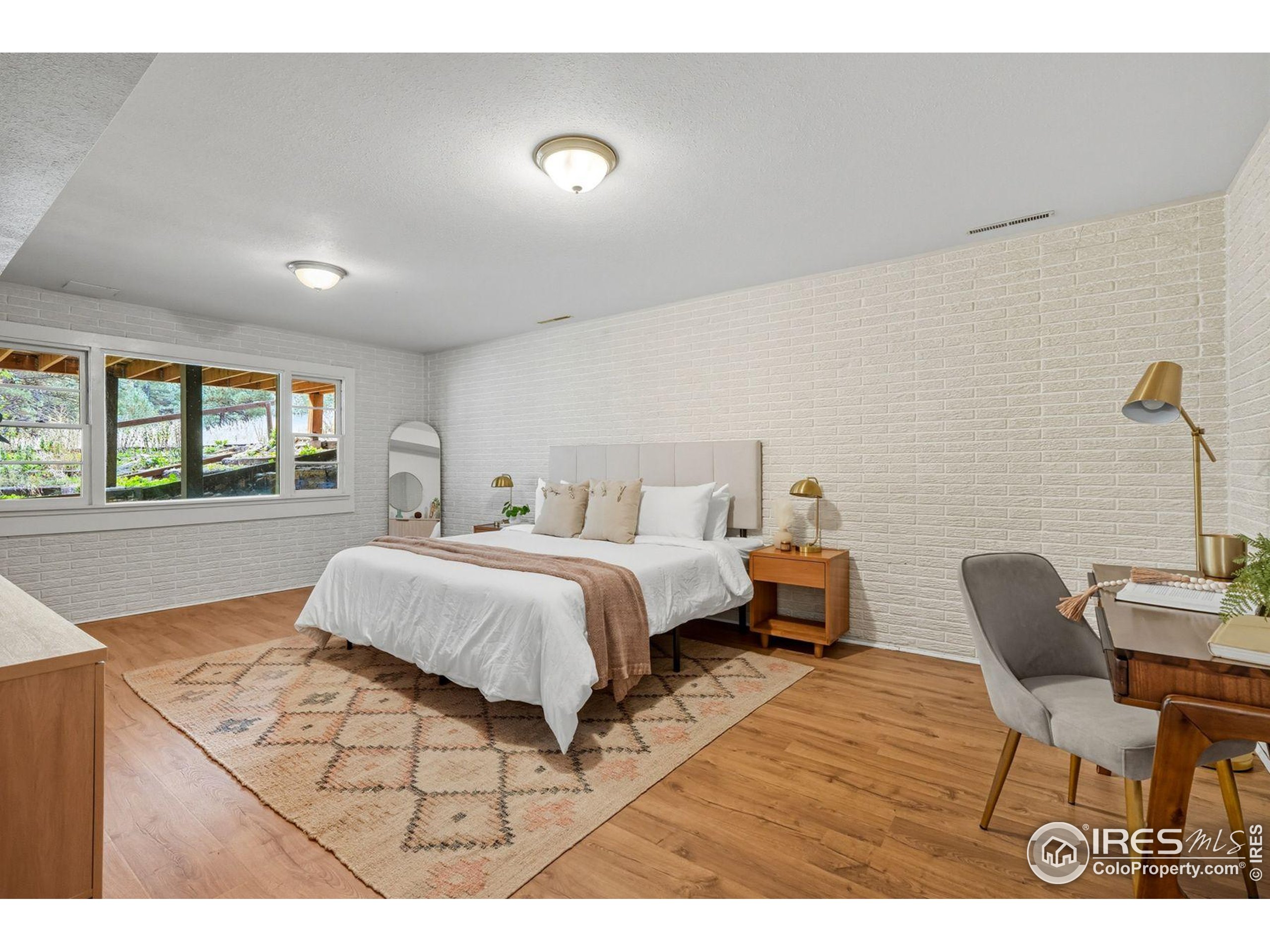 1037 Wagonwheel Gap Road Boulder, CO 80304 - Photo 30 of 43 a bedroom with a bed and a chair