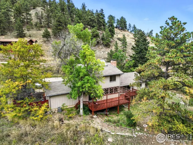 a view of a house with a yard and sitting area