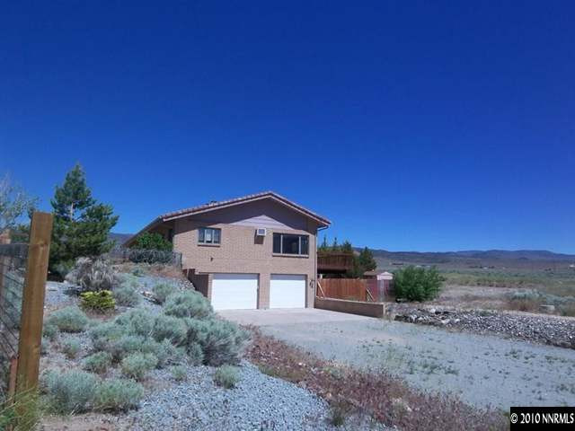 5200 Wilcox Ranch Road Reno, NV 89510 - Photo 1 of 9 a front view of a house with a yard and garage