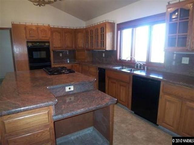 5200 Wilcox Ranch Road Reno, NV 89510 - Photo 2 of 9 a kitchen with kitchen island granite countertop a stove sink and cabinets