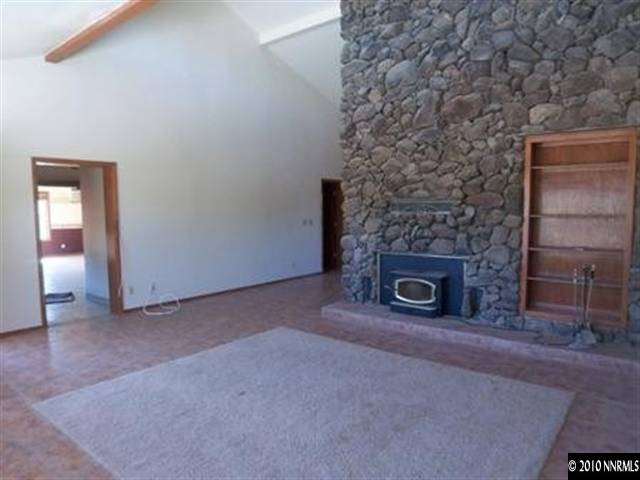 5200 Wilcox Ranch Road Reno, NV 89510 - Photo 3 of 9 an empty room with a fireplace