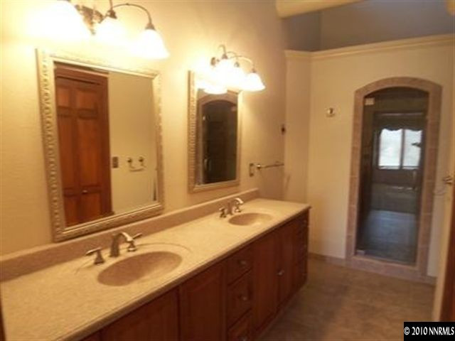 5200 Wilcox Ranch Road Reno, NV 89510 - Photo 4 of 9 a bathroom with a double vanity sink and a mirror