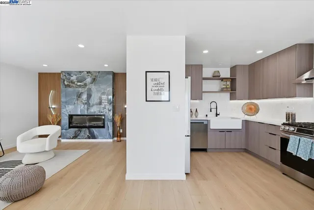 a kitchen with stainless steel appliances a sink a stove and refrigerator