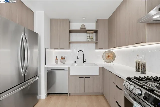 a kitchen with kitchen island a stove and a refrigerator