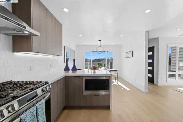 a kitchen with stainless steel appliances a refrigerator and a dining table