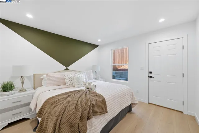 a bedroom with a bed and painting on the wall