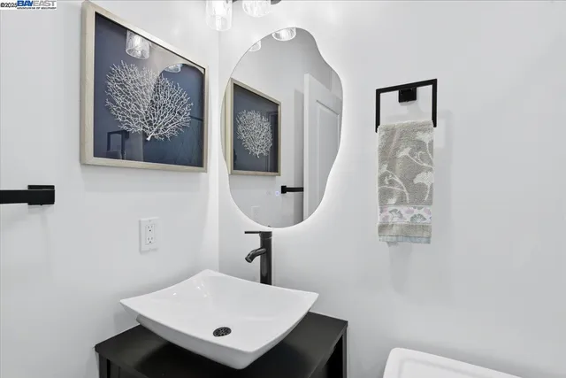 a bedroom with a bed and painting on the wall