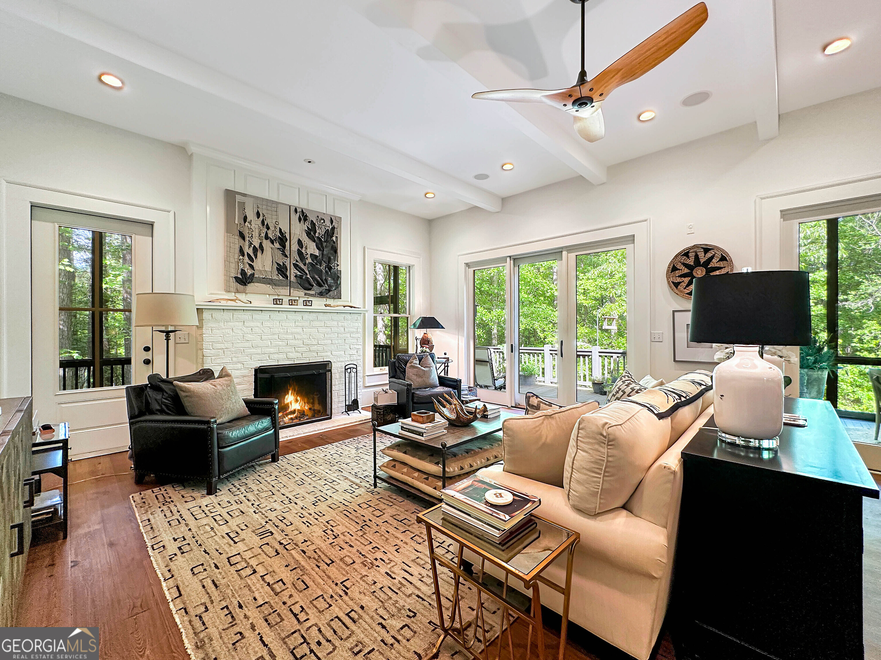 500 Augusta Lane Chattahoochee Hills, GA 30268 - Photo 20 of 49 a living room with furniture a large window and a fireplace
