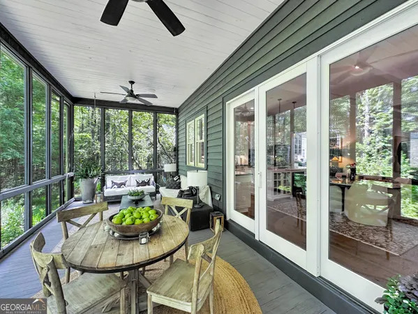 a living room with furniture and a floor to ceiling window