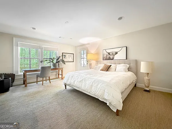 a bedroom with a bed and a large window