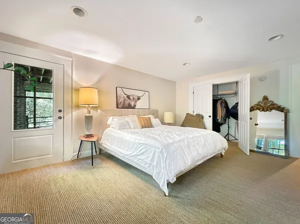 a spacious bedroom with a bed and a window