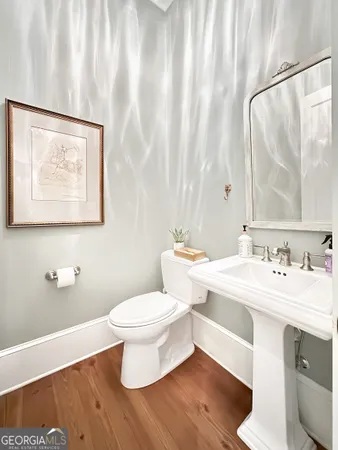 a bathroom with a toilet a sink and a mirror