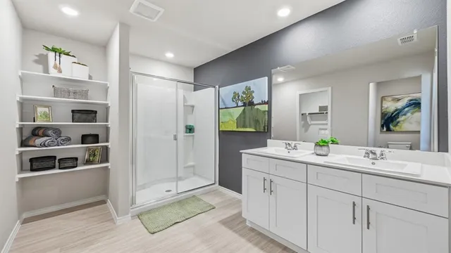 a bedroom with a bed a mirror and a window