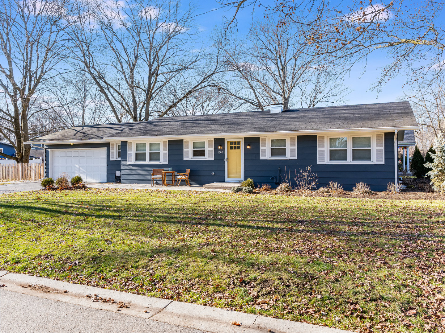 1506 Meadows Road Geneva, IL 60134 - Photo 1 of 33 a front view of a house with a yard table and chairs