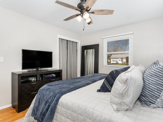1506 Meadows Road Geneva, IL 60134 - Photo 16 of 33 a bedroom with a bed and a flat screen tv