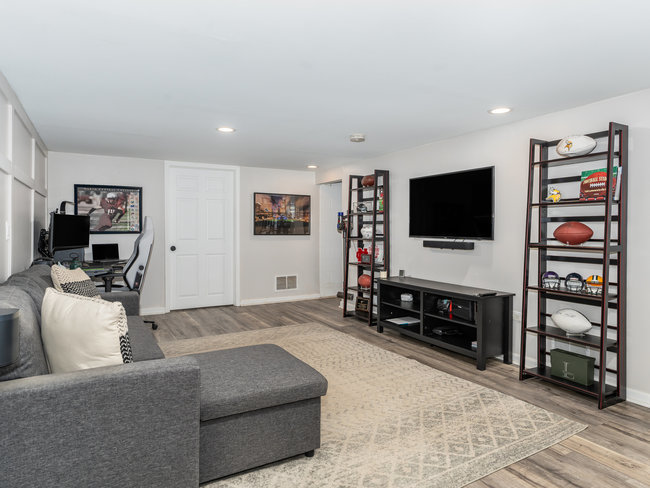 1506 Meadows Road Geneva, IL 60134 - Photo 23 of 33 a living room with furniture and a flat screen tv