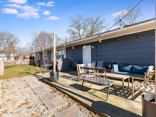 1506 Meadows Road Geneva, IL 60134 - Photo 28 of 33 a view of a patio with table and chairs with wooden floor and fence
