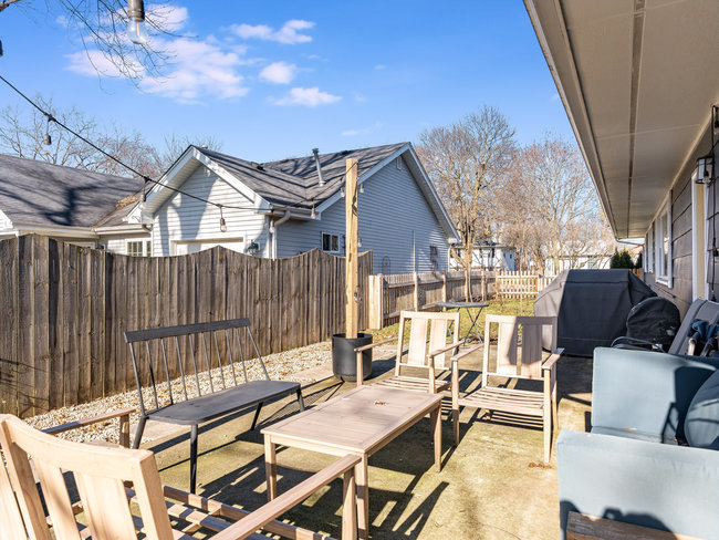 1506 Meadows Road Geneva, IL 60134 - Photo 30 of 33 a view of a patio with a dining table and chairs with wooden floor
