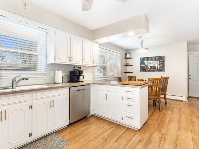 1506 Meadows Road Geneva, IL 60134 - Photo 6 of 33 a kitchen with white cabinets and white appliances