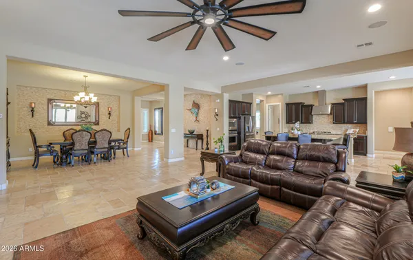 a living room with furniture a piano and a window