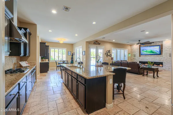 a spacious bathroom with a granite countertop sink and a mirror