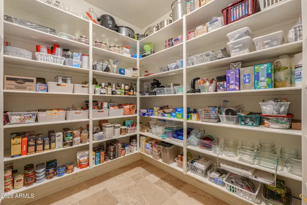 a view of walk in closet with clothes